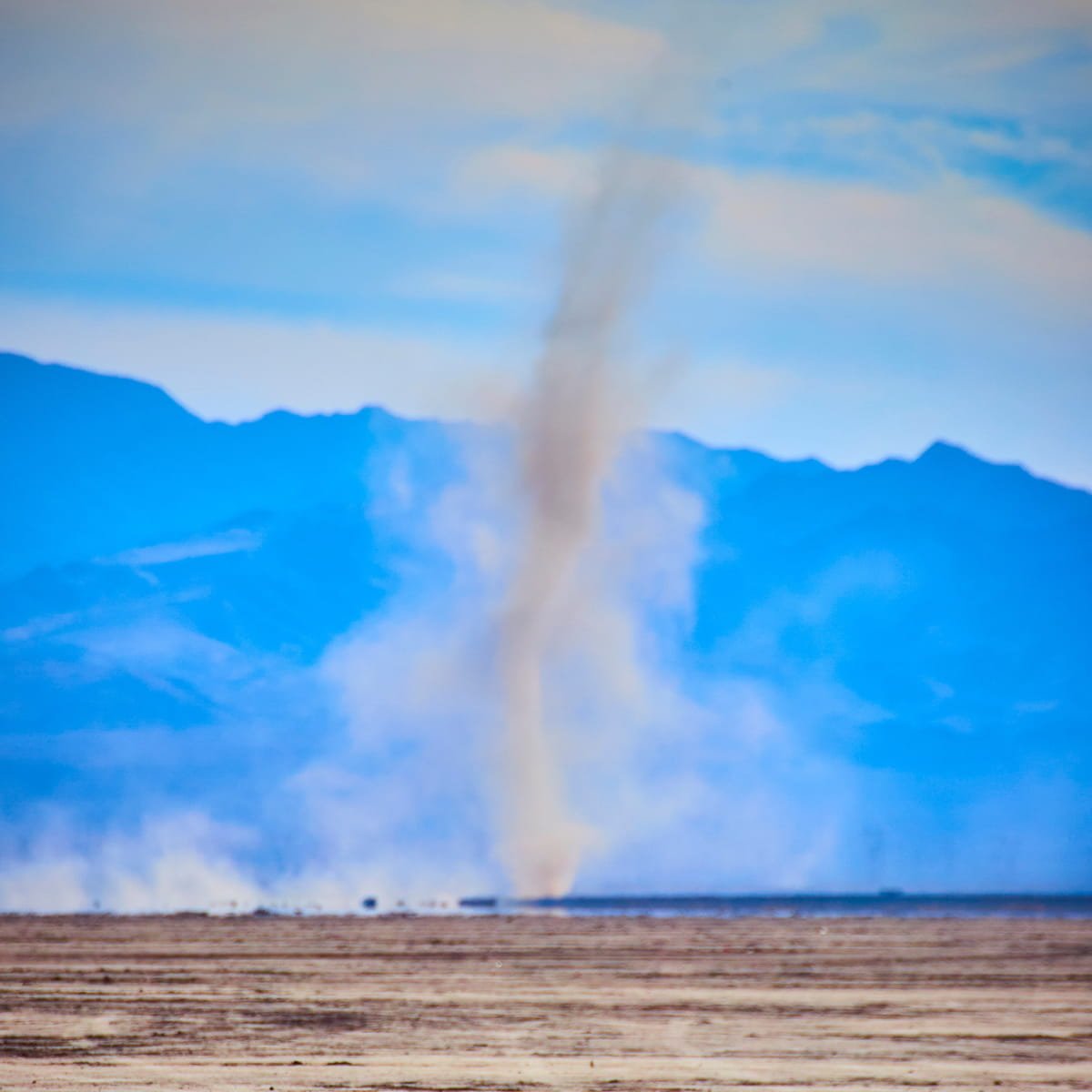 A powerful dust devil swirls across the barren desert of Boulder City Dry Lake Bed in Nevada